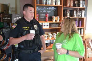 Locals share a cup of coffee with Lemoore Police Officers in department outreach Officer Anthony Braley with Becky Cardwell at Starbucks.